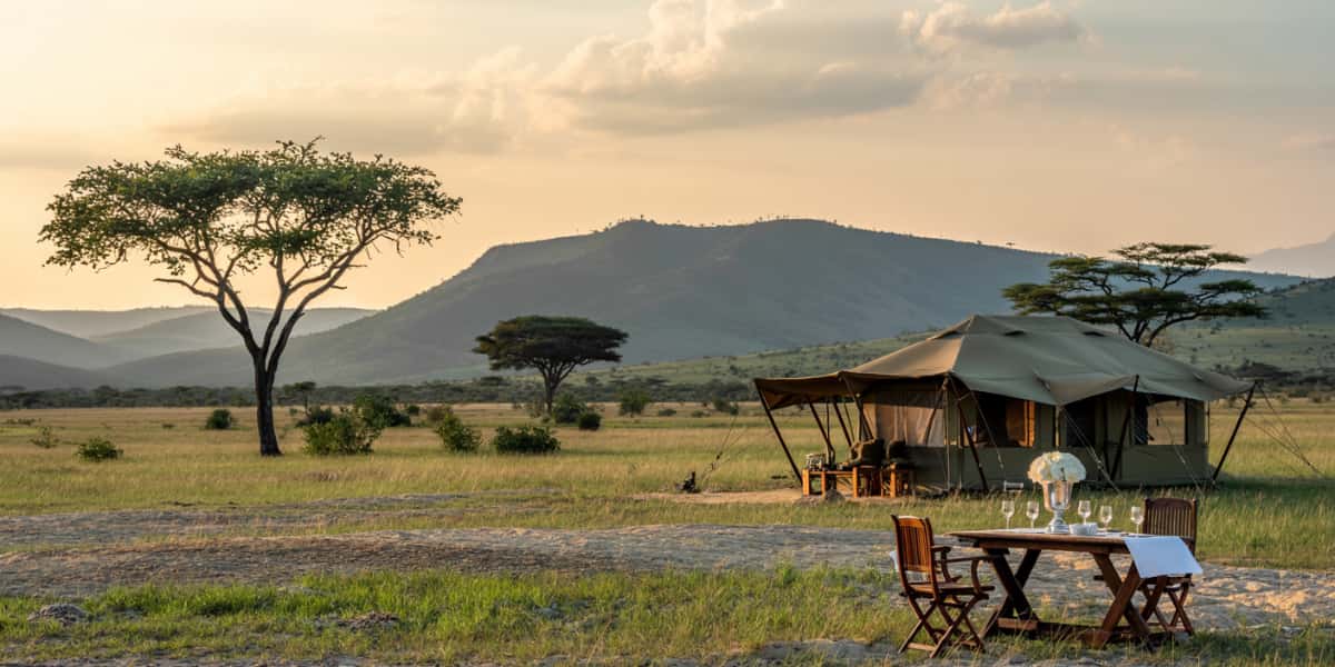 Tented camp at sunset in the African bush